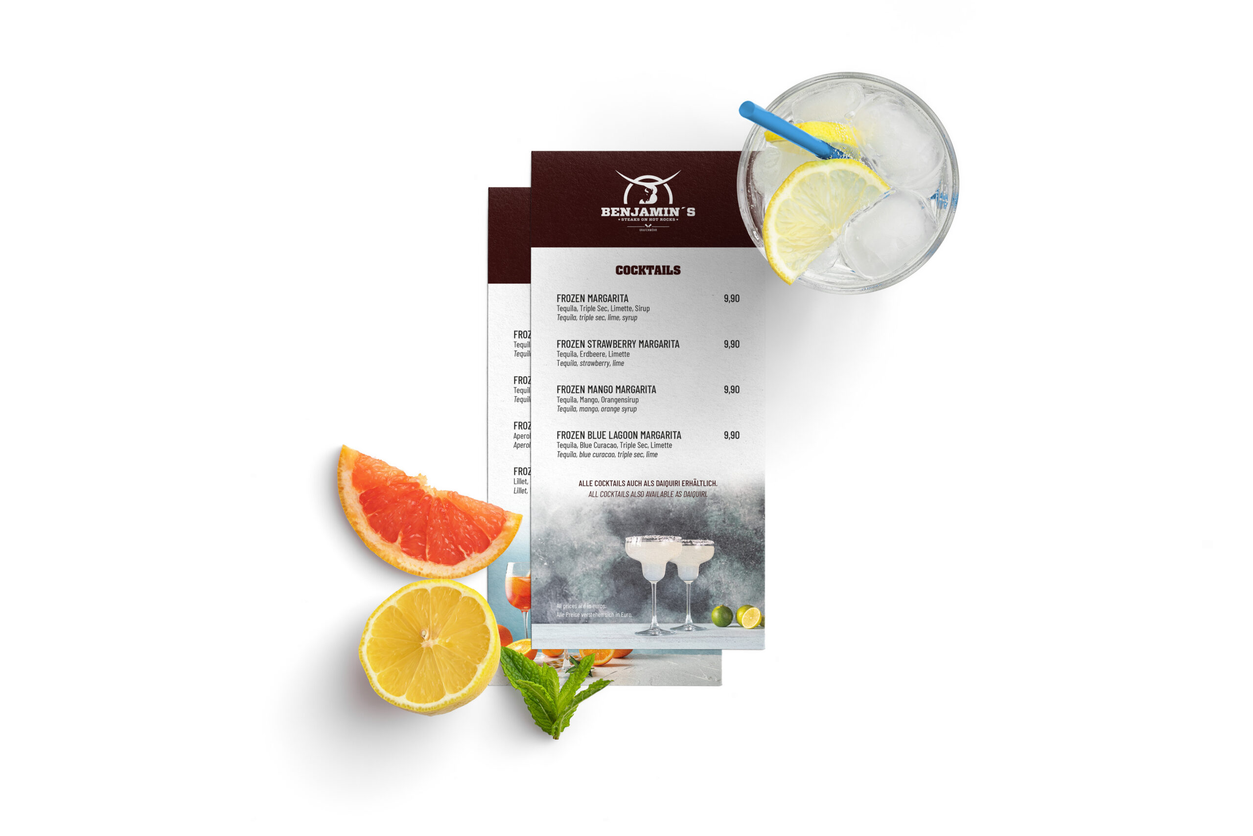 Cocktailkarte mit frischen Zutaten Gestaltete Cocktailkarte von „Benjamin’s“ mit verschiedenen Margarita-Varianten und Preisangaben. Daneben liegen Zitronen- und Grapefruitscheiben, Minzblätter sowie ein Glas mit Eis und Zitronenscheibe.